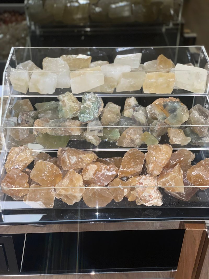 Collection of tumbled stones, raw minerals, and crystal clusters