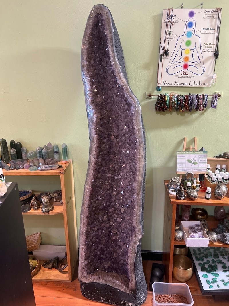 Retail shelving with organized crystals, stones, and spiritual products