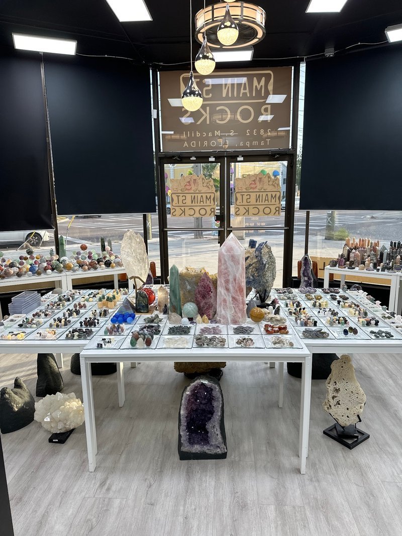 Variety of gemstones, crystal carvings, and polished mineral specimens