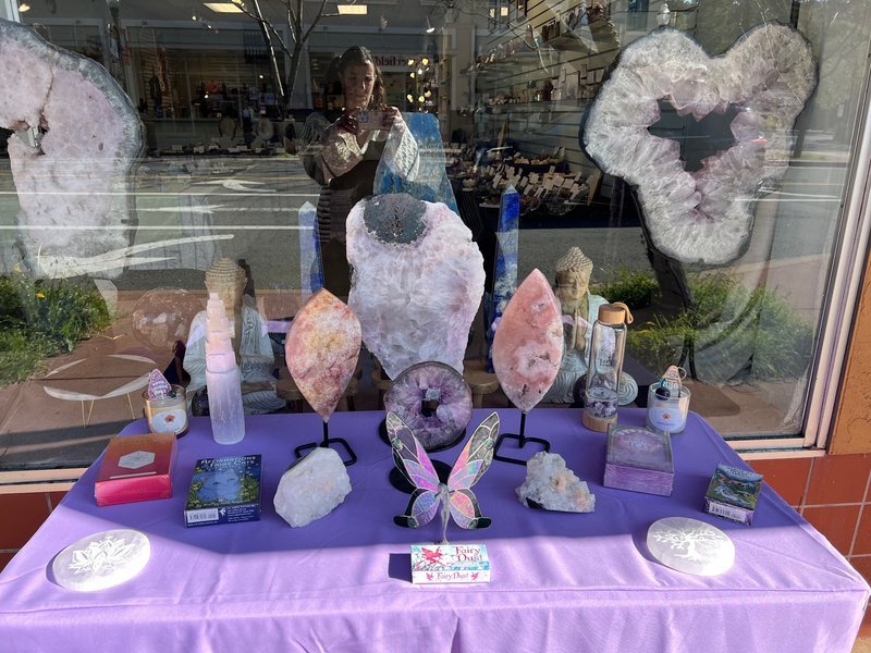 Retail shelving with organized crystals, stones, and spiritual products