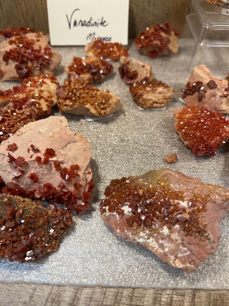 Display featuring crystal points, polished stones, and raw mineral specimens