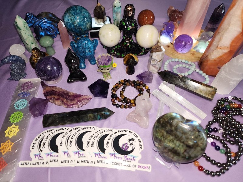 Variety of gemstones, crystal carvings, and polished mineral specimens