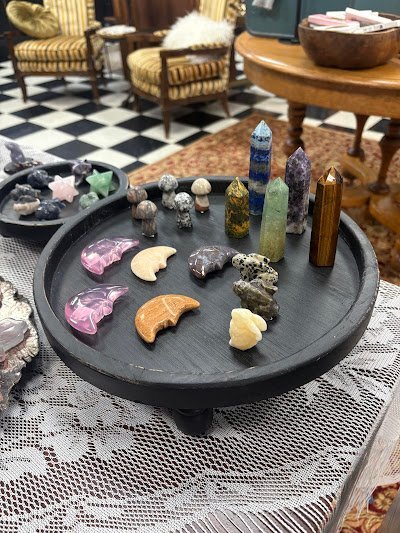 Shelving featuring chakra stones, healing crystals, and mineral specimens