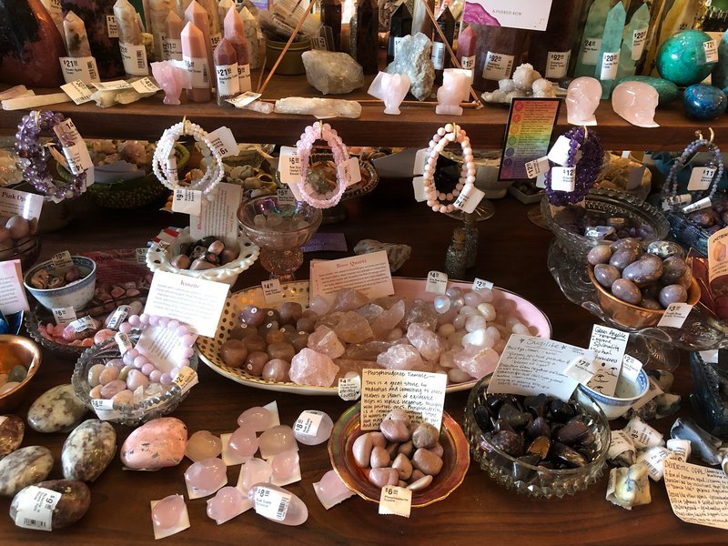 Display featuring crystal points, polished stones, and raw mineral specimens