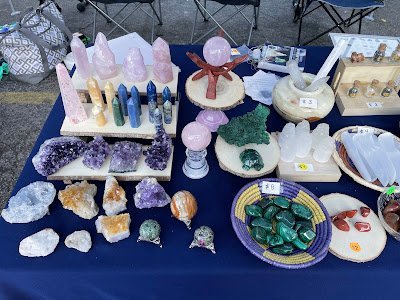 Display featuring crystal points, polished stones, and raw mineral specimens