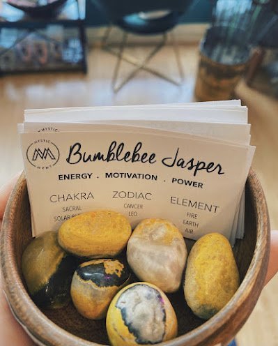 Collection of tumbled stones, raw minerals, and crystal clusters
