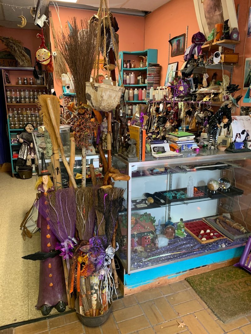 Shelving display featuring amethyst, quartz, and various crystal specimens