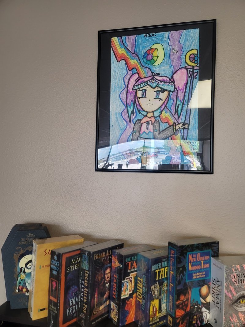 Modern minimalist shop display with black shelving, houseplants, and curated crystal selection