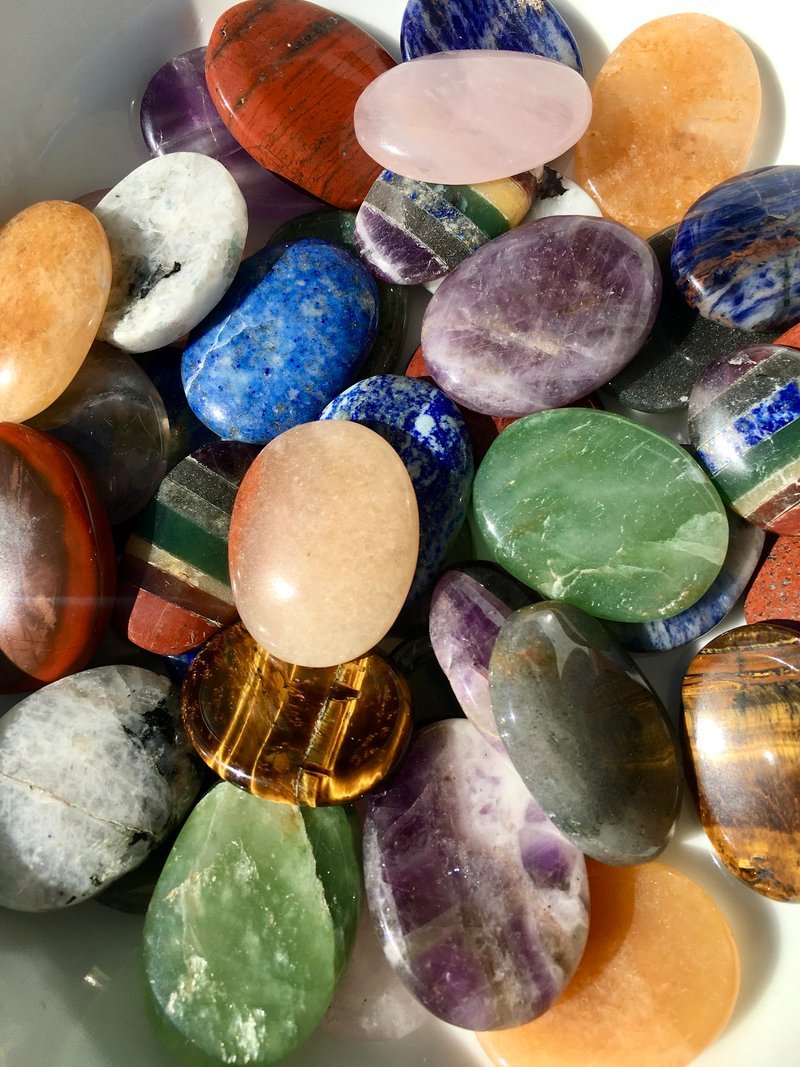 Framed colorful artwork above shelf displaying tarot books and metaphysical literature