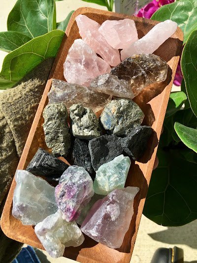 Collection of polished worry stones including lapis lazuli, rose quartz, aventurine, and fluorite