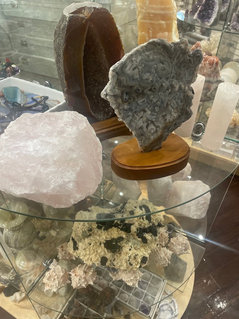 Display of polished crystal specimens, geodes, and mineral towers