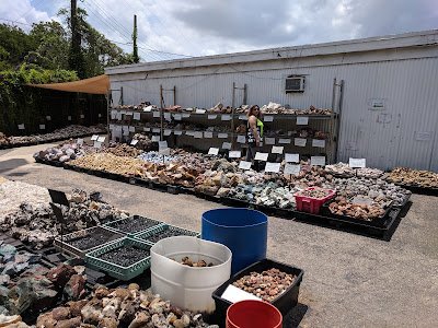 Outdoor display area with organized bins of rocks, minerals, and fossils