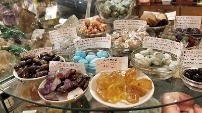Retail shelving with organized crystals, stones, and spiritual products