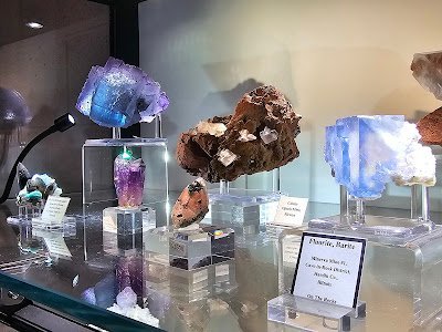 Shelving featuring chakra stones, healing crystals, and mineral specimens