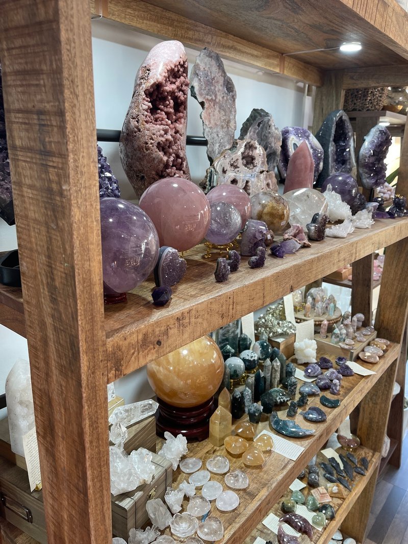 Collection of tumbled stones, raw minerals, and crystal clusters