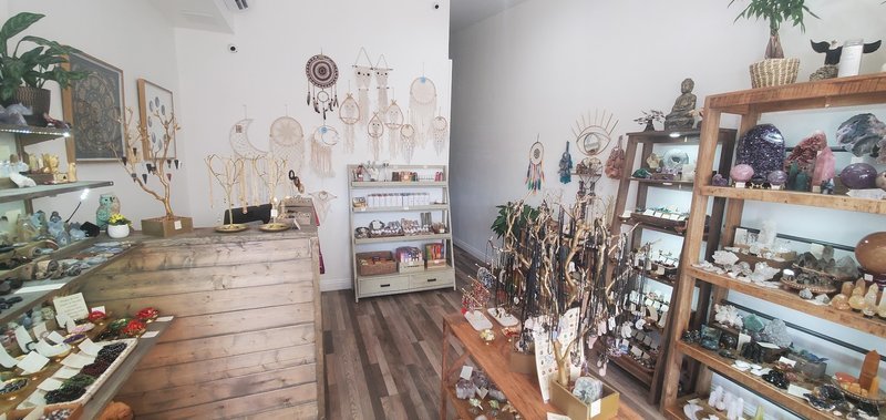 Retail shelving with organized crystals, stones, and spiritual products
