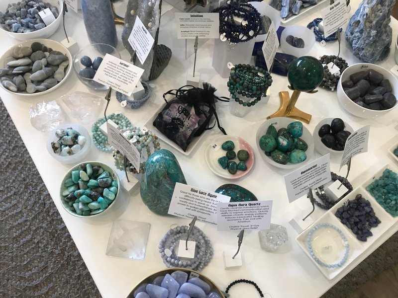 Retail shelving with organized crystals, stones, and spiritual products