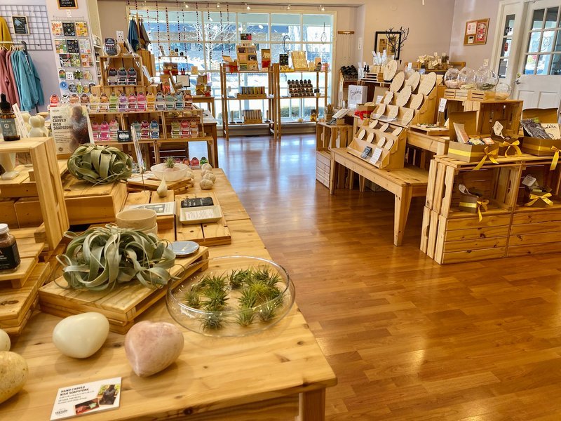 Shelving display featuring amethyst, quartz, and various crystal specimens