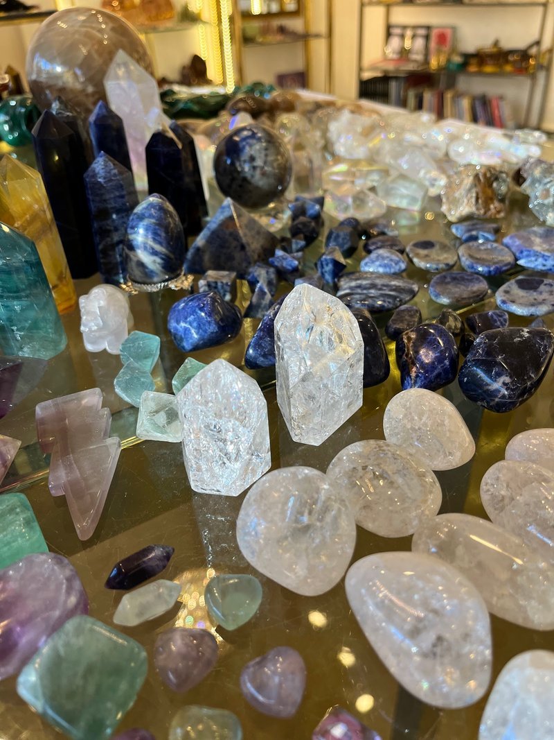 Display featuring crystal points, polished stones, and raw mineral specimens