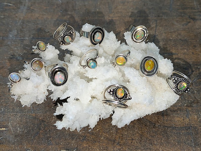 Variety of gemstones, crystal carvings, and polished mineral specimens