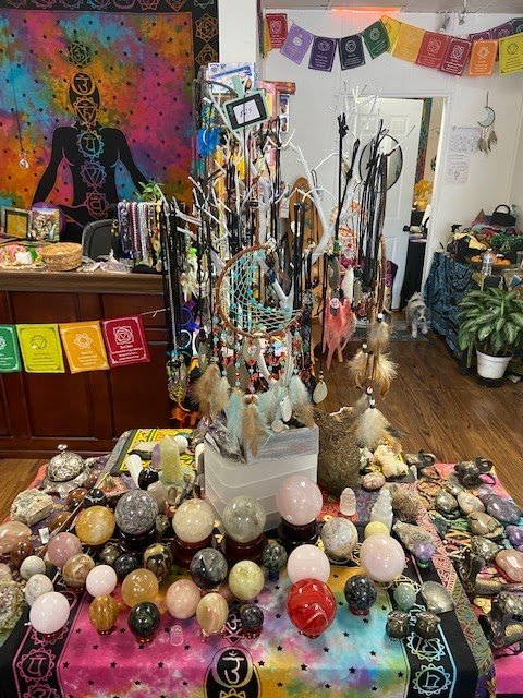 Display featuring crystal points, polished stones, and raw mineral specimens