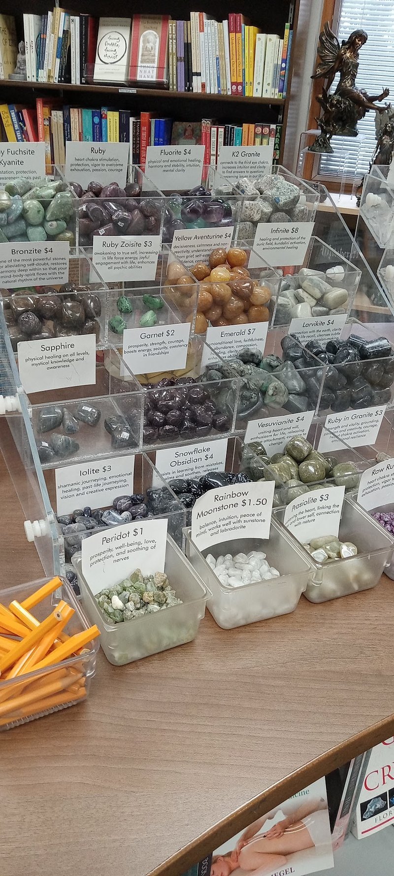 Retail shelving with organized crystals, stones, and spiritual products