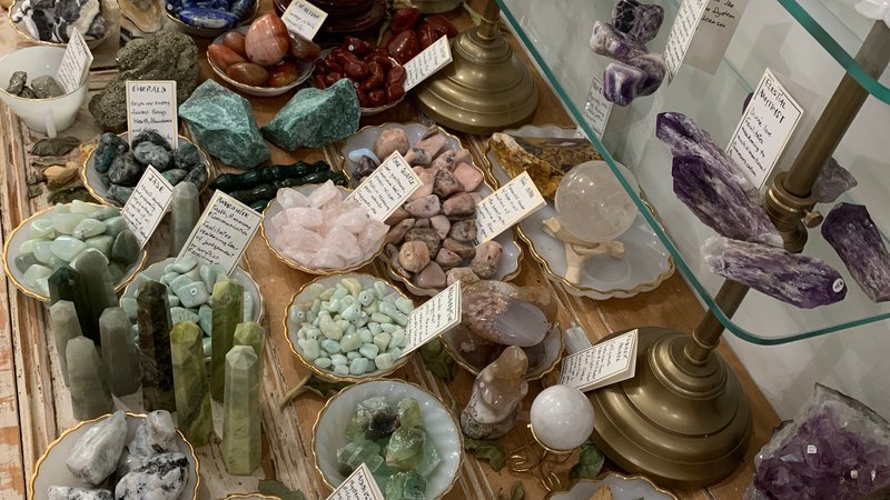 Organized crystal display with labeled stones and healing minerals