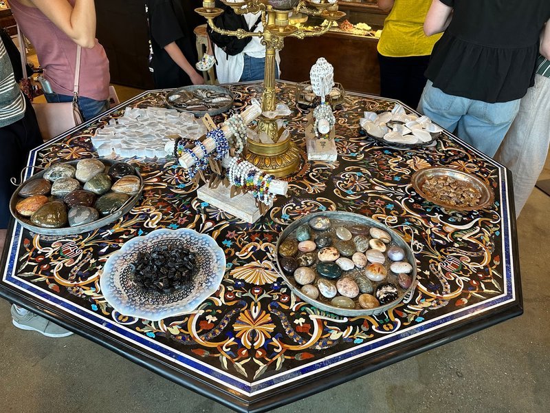 Variety of gemstones, crystal carvings, and polished mineral specimens