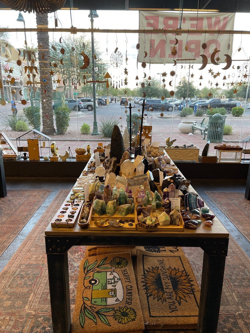 Retail shelving with organized crystals, stones, and spiritual products