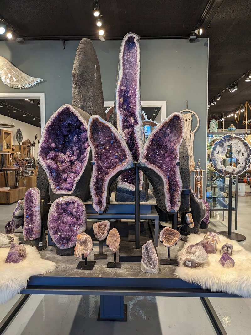Display featuring crystal points, polished stones, and raw mineral specimens