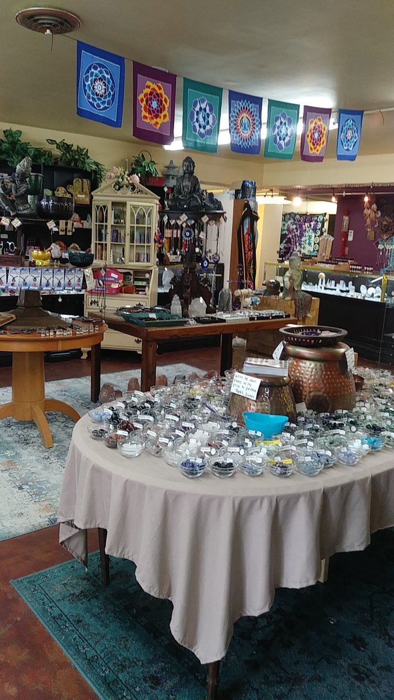 Retail shelving with organized crystals, stones, and spiritual products