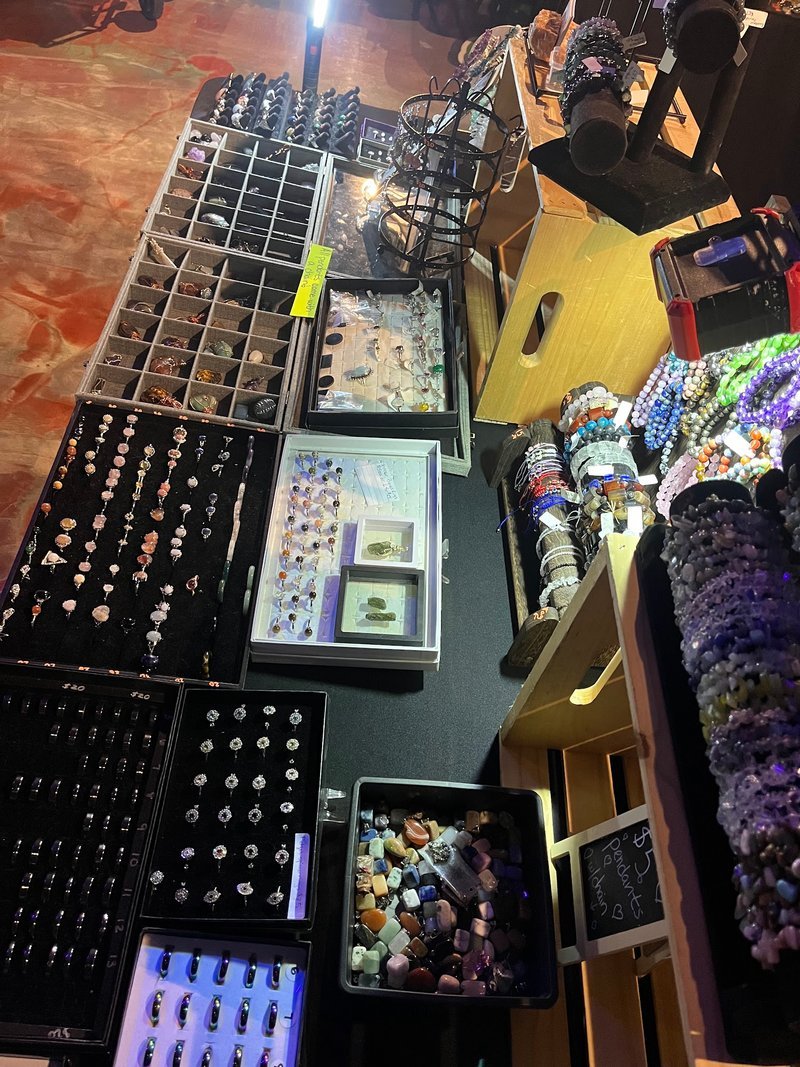 Retail shelving with organized crystals, stones, and spiritual products