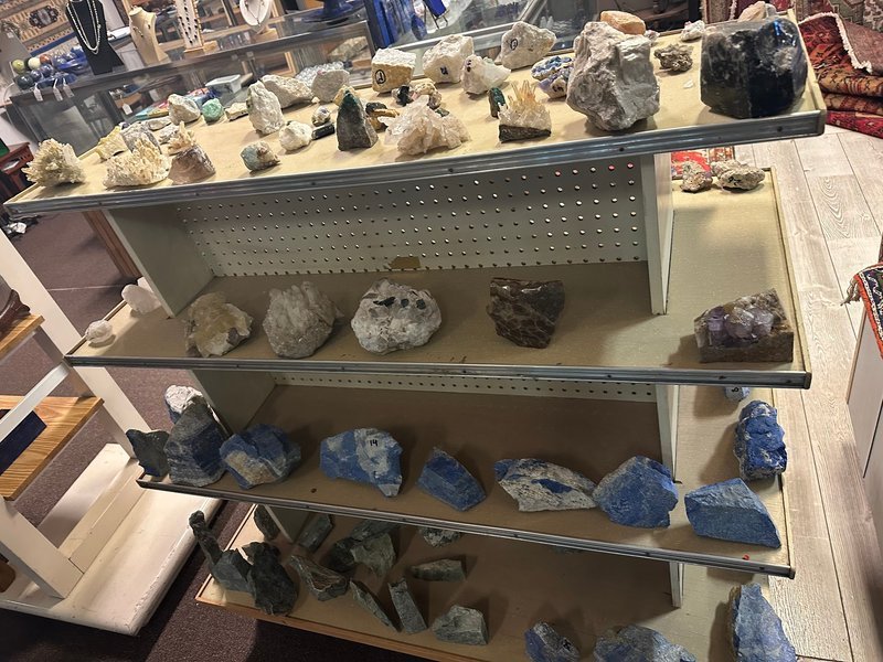 Variety of gemstones, crystal carvings, and polished mineral specimens