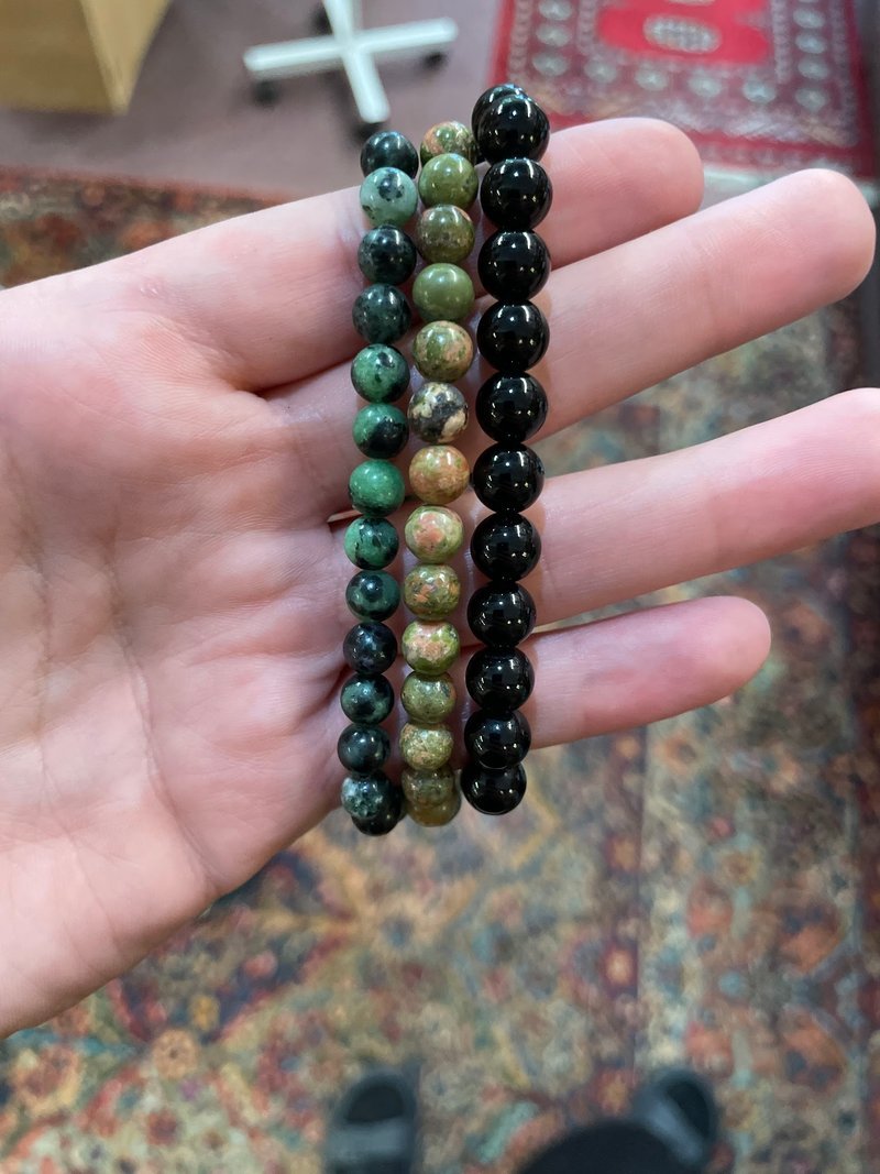 Shelving display featuring amethyst, quartz, and various crystal specimens