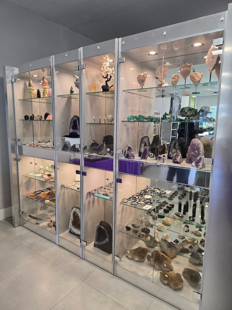 Variety of gemstones, crystal carvings, and polished mineral specimens