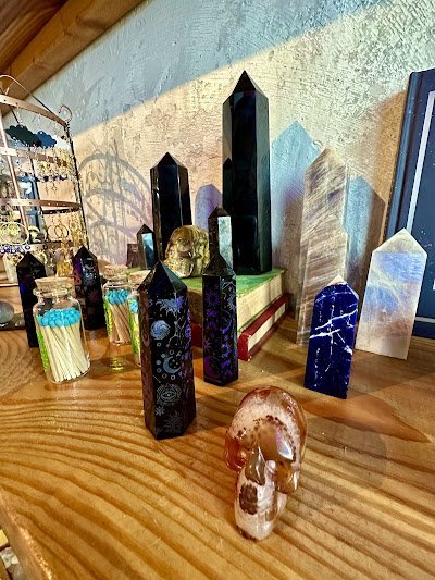 Display featuring crystal points, polished stones, and raw mineral specimens