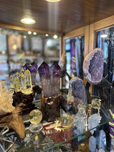 Crystal specimens and minerals displayed with spiritual and metaphysical items