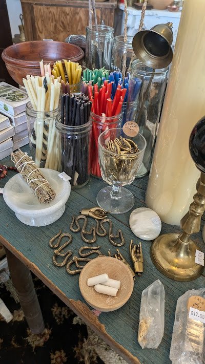 Crystal specimens and minerals displayed with spiritual and metaphysical items