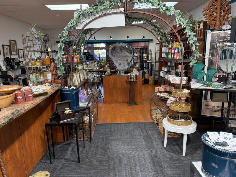 Shelving display featuring amethyst, quartz, and various crystal specimens