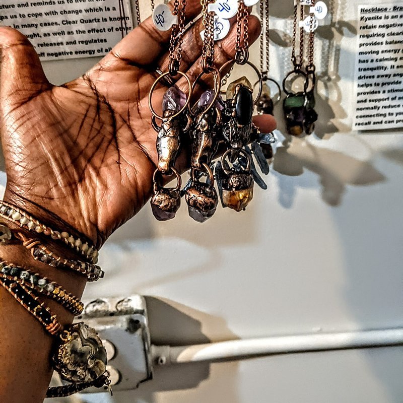 Display featuring crystal points, polished stones, and raw mineral specimens
