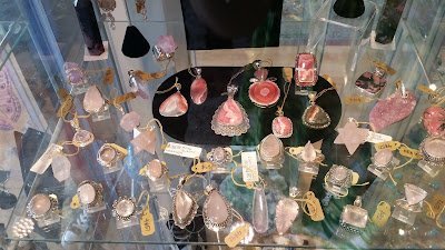 Retail shelving with organized crystals, stones, and spiritual products