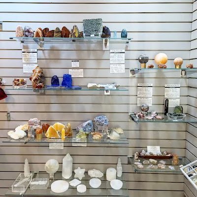 Organized crystal display with labeled stones and healing minerals