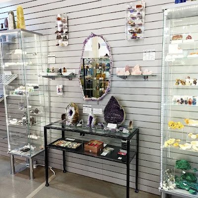 Retail shelving with organized crystals, stones, and spiritual products
