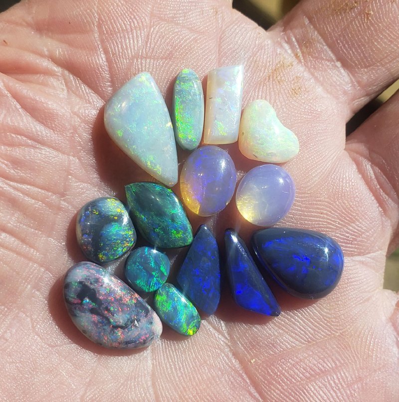 Variety of gemstones, crystal carvings, and polished mineral specimens