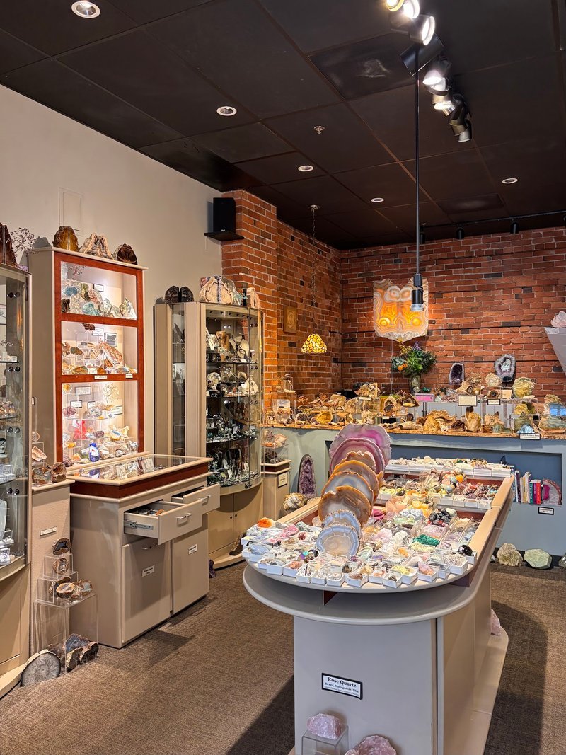 Display of polished crystal specimens, geodes, and mineral towers