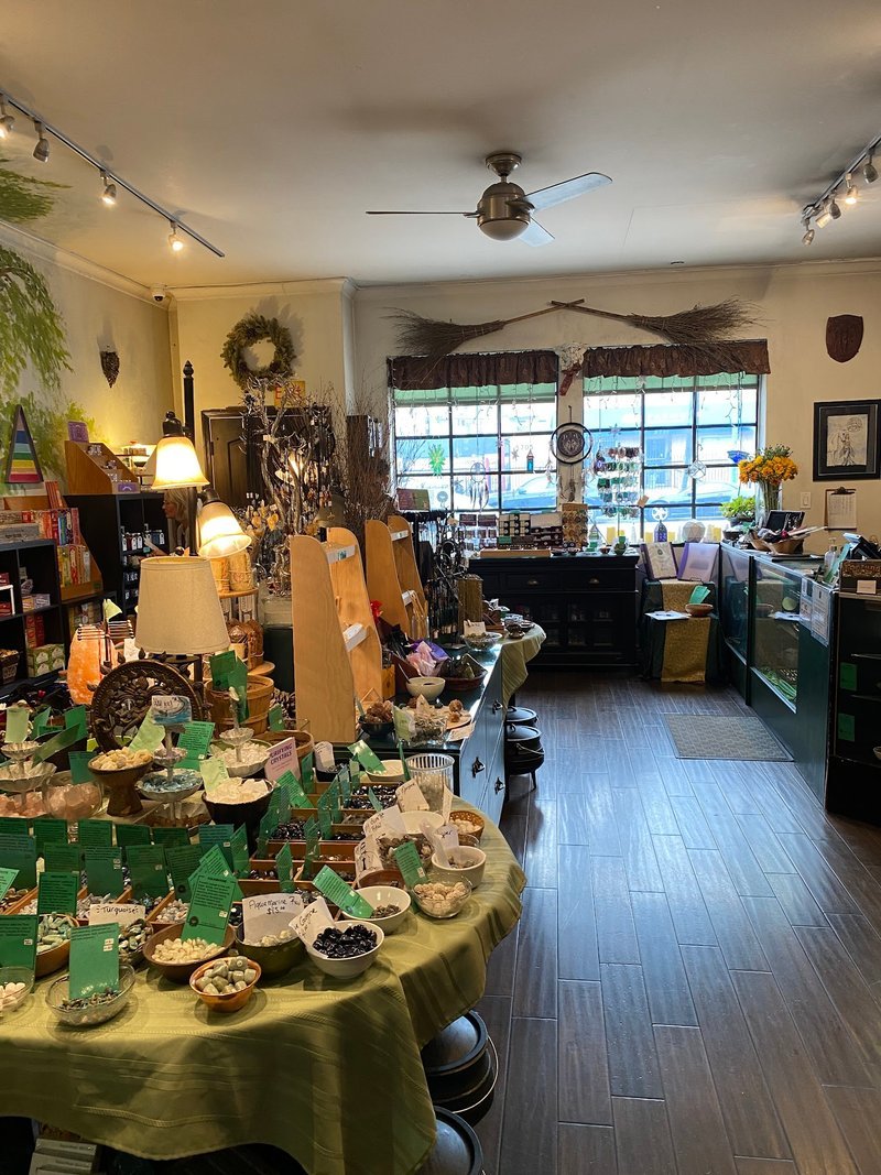Shelving display featuring amethyst, quartz, and various crystal specimens