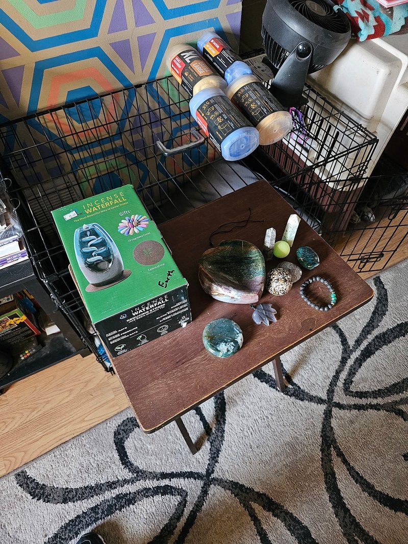 Display featuring crystal points, polished stones, and raw mineral specimens