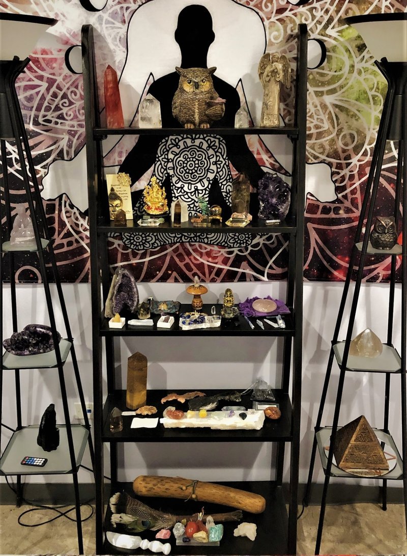 Shelving display featuring amethyst, quartz, and various crystal specimens