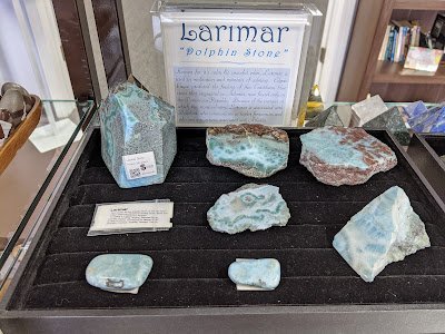 Shelving featuring chakra stones, healing crystals, and mineral specimens