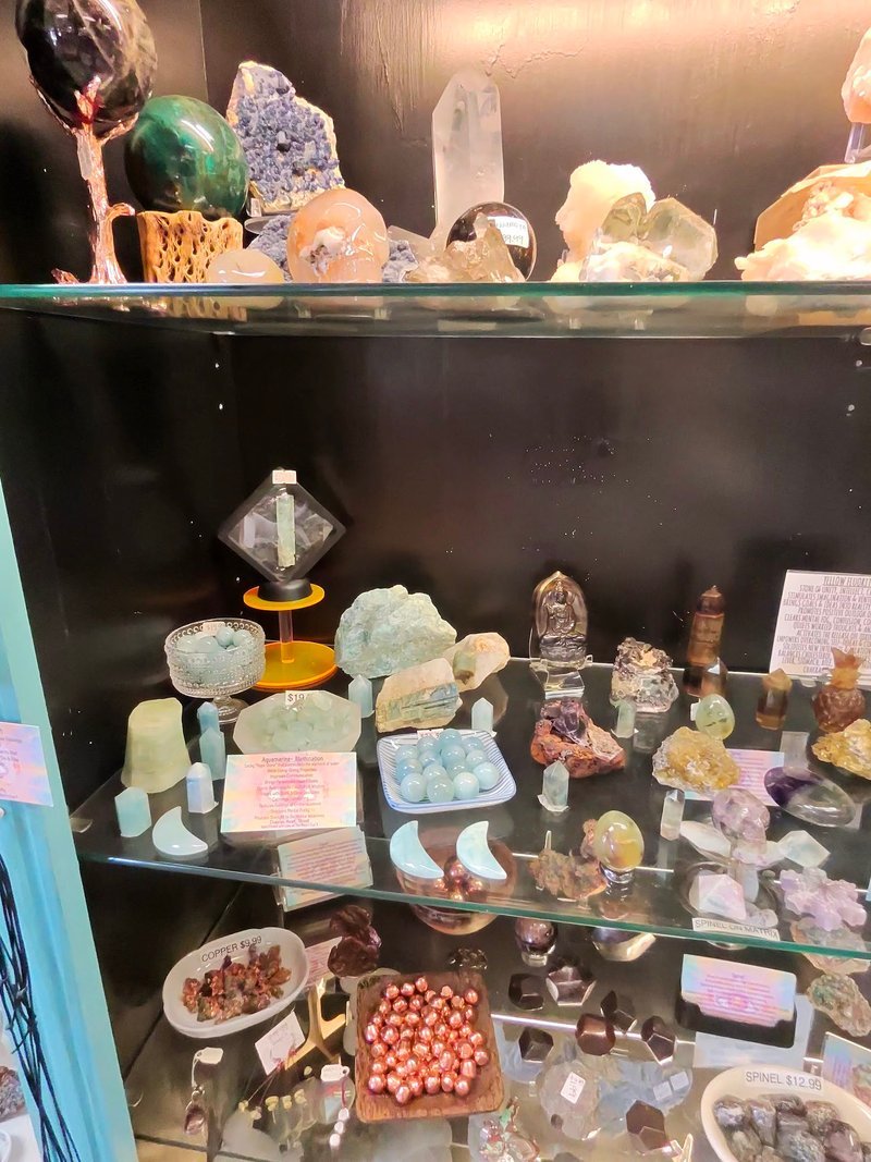 Display of polished crystal specimens, geodes, and mineral towers